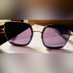 Prada Black Frame Sunglasses with Purple Lenses and Gold Accents